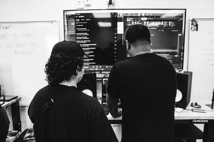 Two students working at a production screen